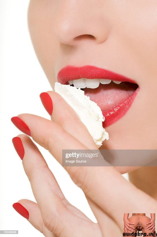 woman cream getty licking finger